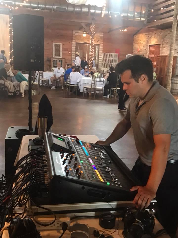AV technician operating event sound equipment